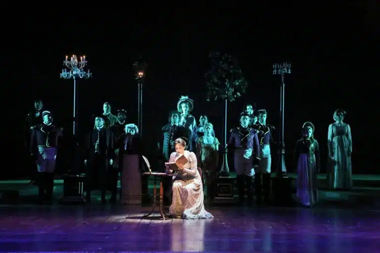actors on stage in old time clothing during pride and prejudice era