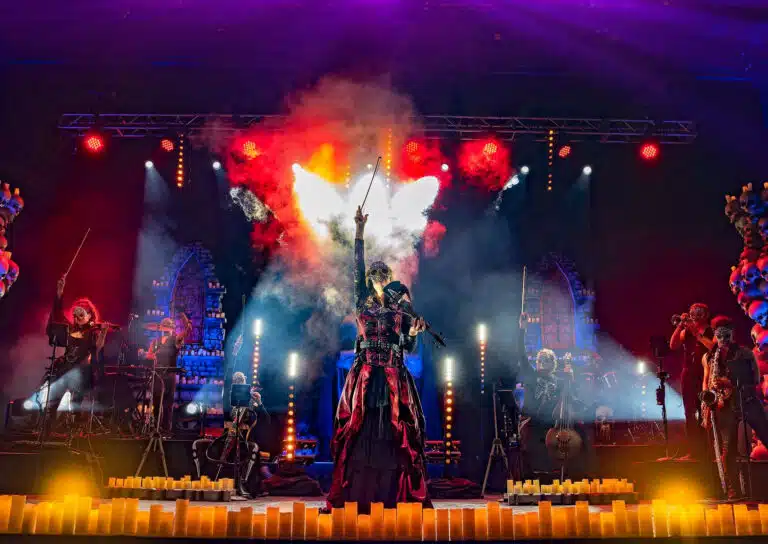 Rock musicans performing by candelight on stage