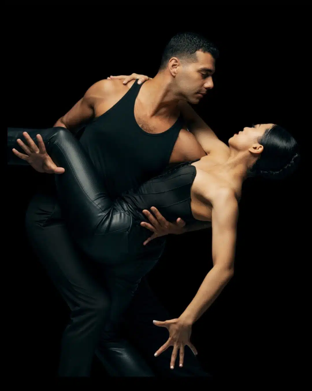 two dancers posing wearing black
