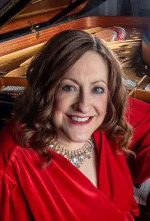 Woman in red top smiling at the camera