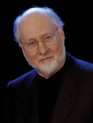man with glasses in a black suit