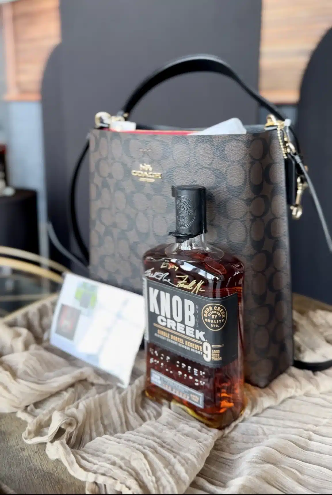 a designer Coach handbag and an autographed bottle of Knob Creek