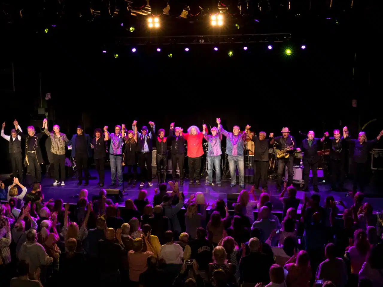 group photo of performers from happy together tour taking a bow on stage