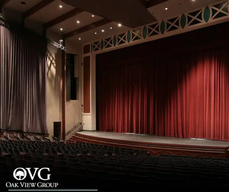 theatre seating with curtain down on stage