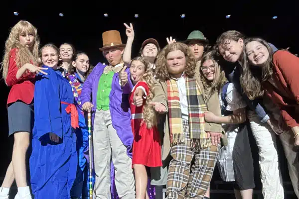 group photo of summer camp students dressed as characters from Willy Wonka