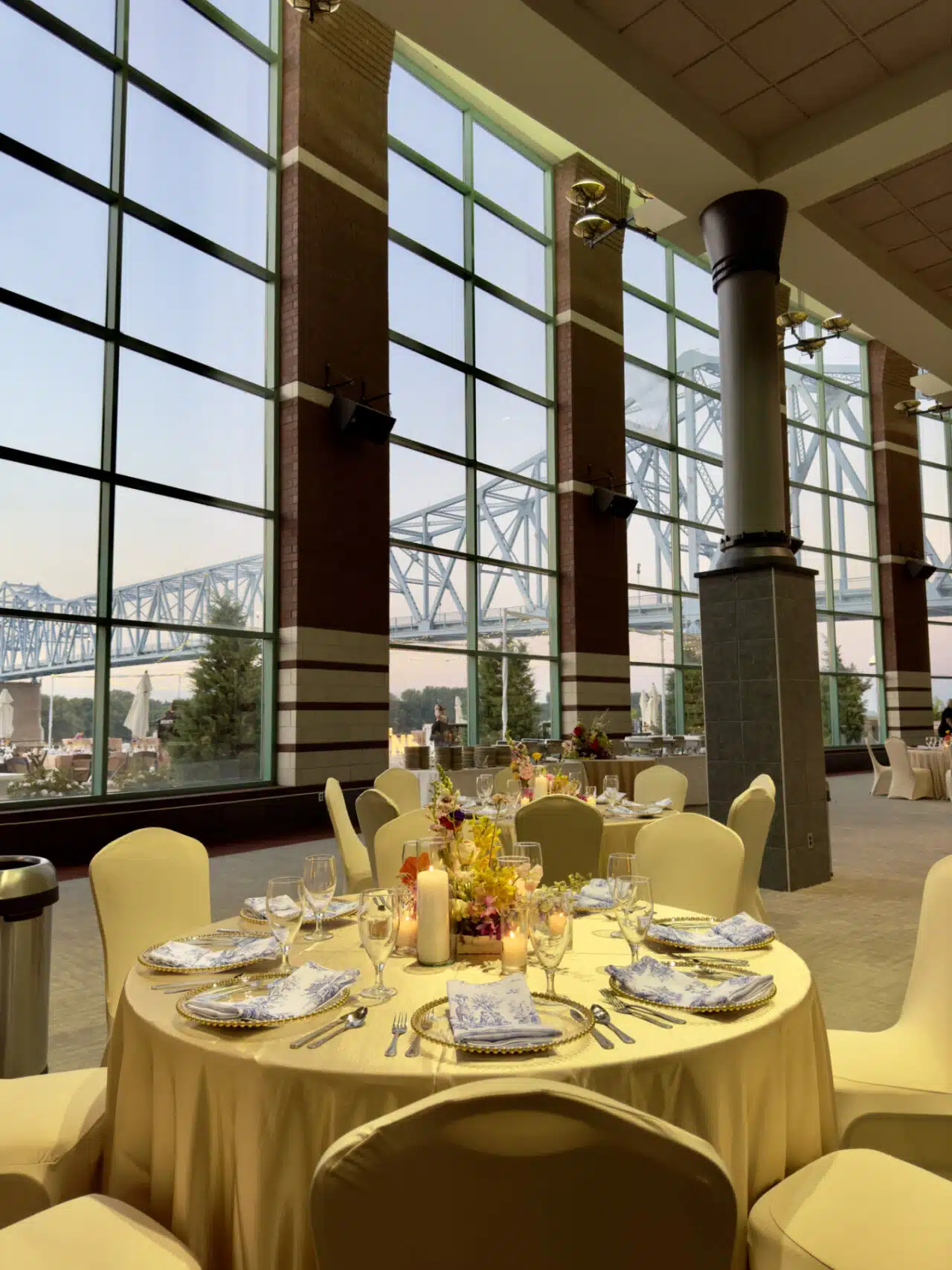 Table setting with golden tablecloths and chair covers in the RiverPark Center lobby