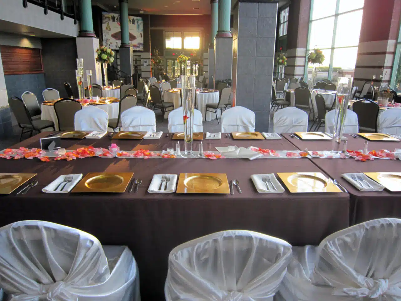 A deep-brown themed table setting for a wedding in the lobby of the RiverPark Center