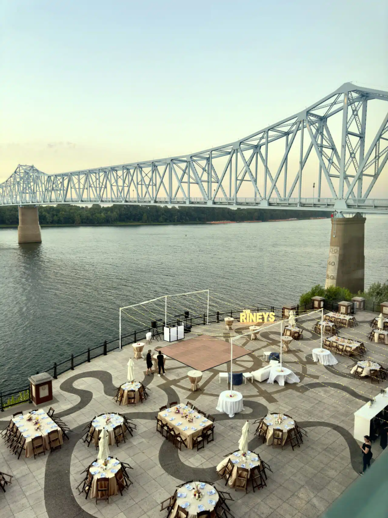 Overhead view of a wedding setup on the RiverPark center patio, with the bridge in the background