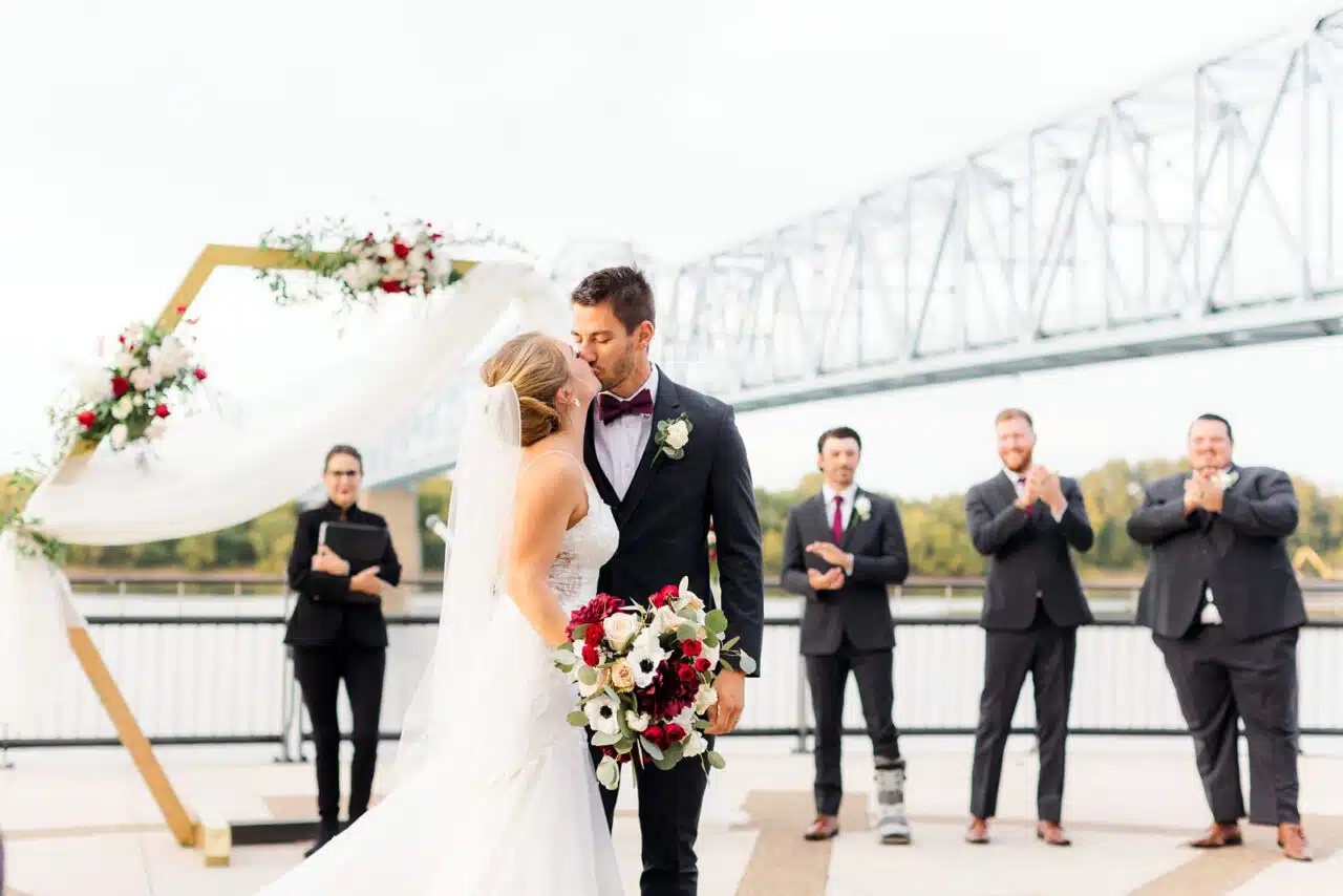 A bride and groom kiss on the RiverPark Center Plaza