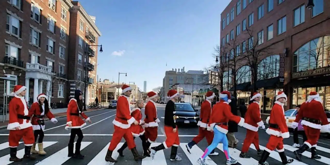 People dressed as santa walking down the street