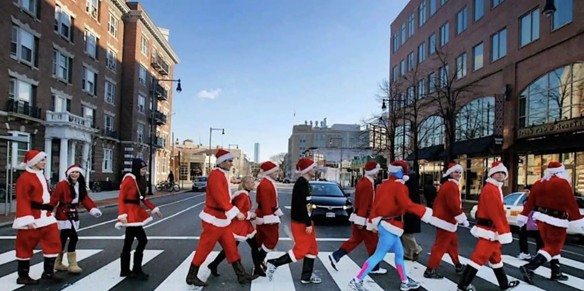 People dressed as santa walking down the street